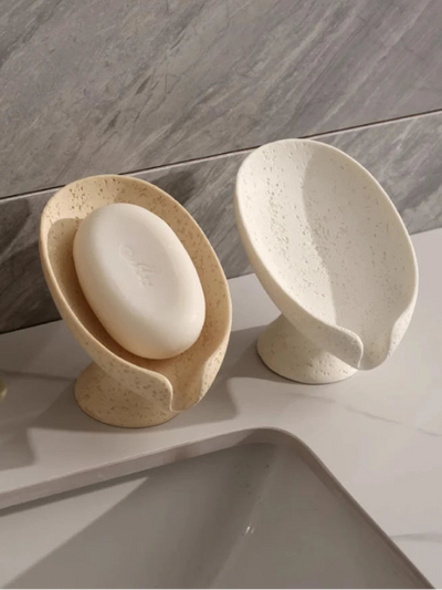 Soap dish with a bar of soap on a bathroom counter
