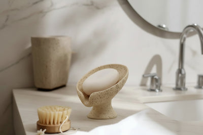 Soap dish with a bar of soap on a neutral background