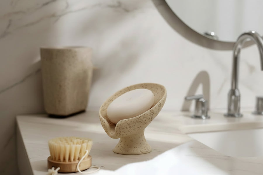 Soap dish with a bar of soap on a neutral background